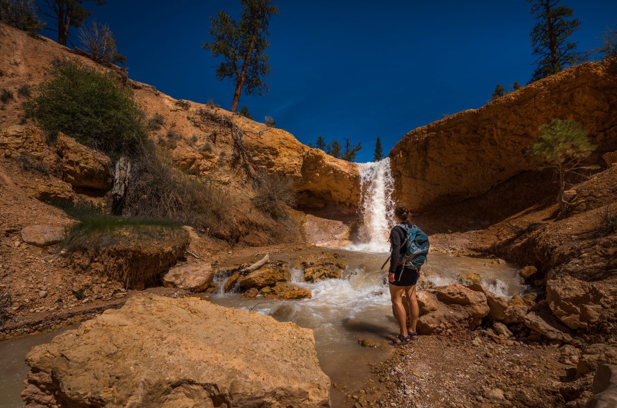 Backpacker Girl Exploring Bryce Canyon Waterfall near Mossy Cave USA travel landscapes
